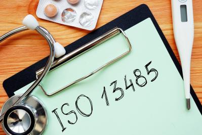 iso 13485 is shown on a business photo using the text